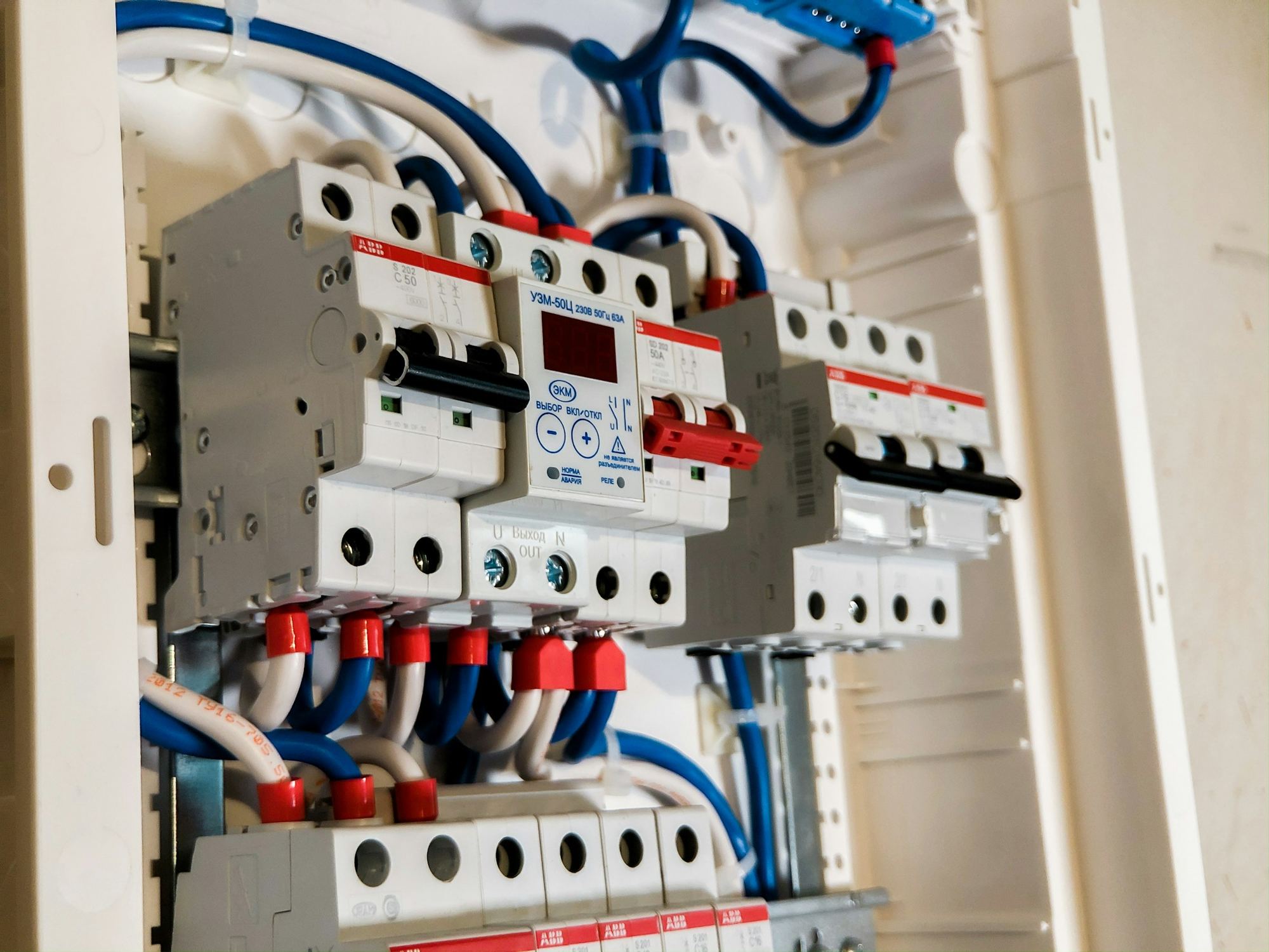 A row of white circuit breakers in a distribution board